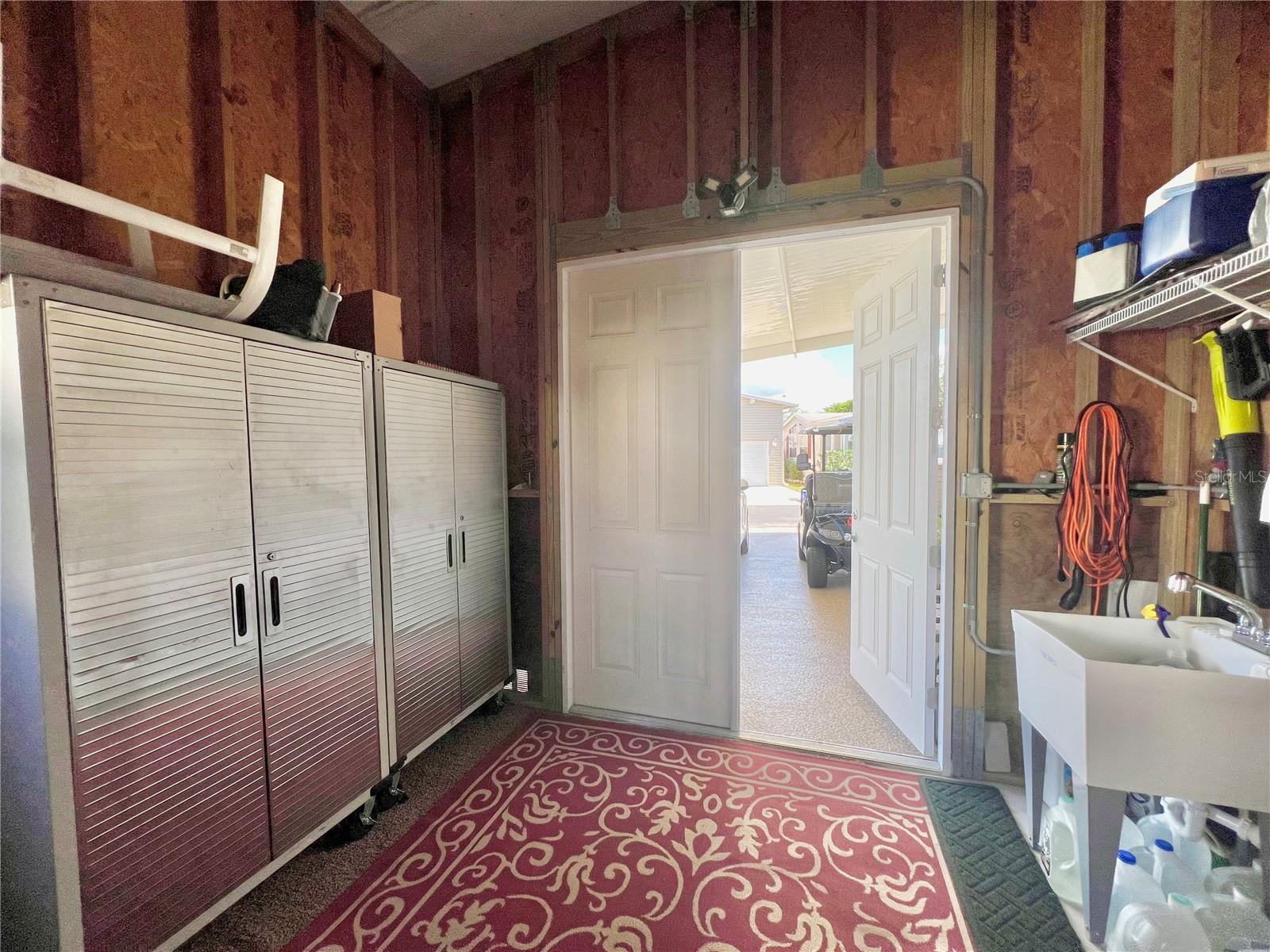 Shed with double entry door for indoor golf cart parking.