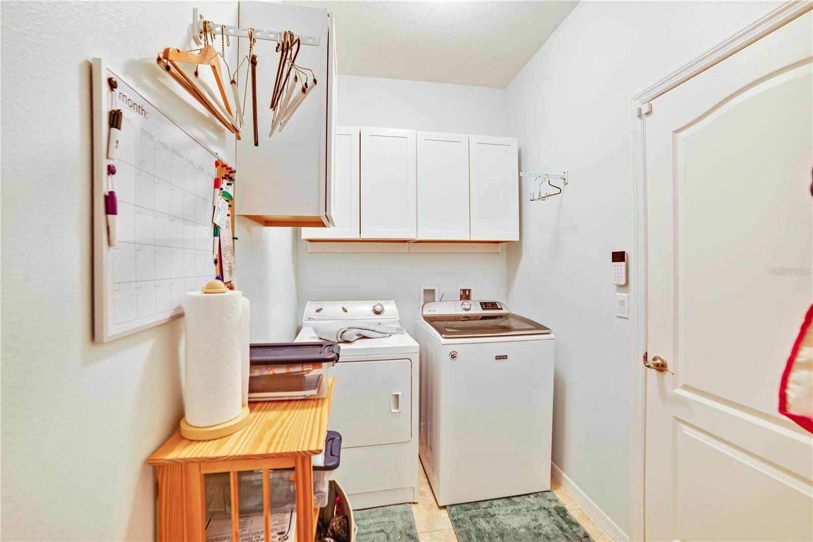 EQUIPPED LAUNDRY ROOM IS ADJACENT TO THE ENTRY FOYER AND GARAGE