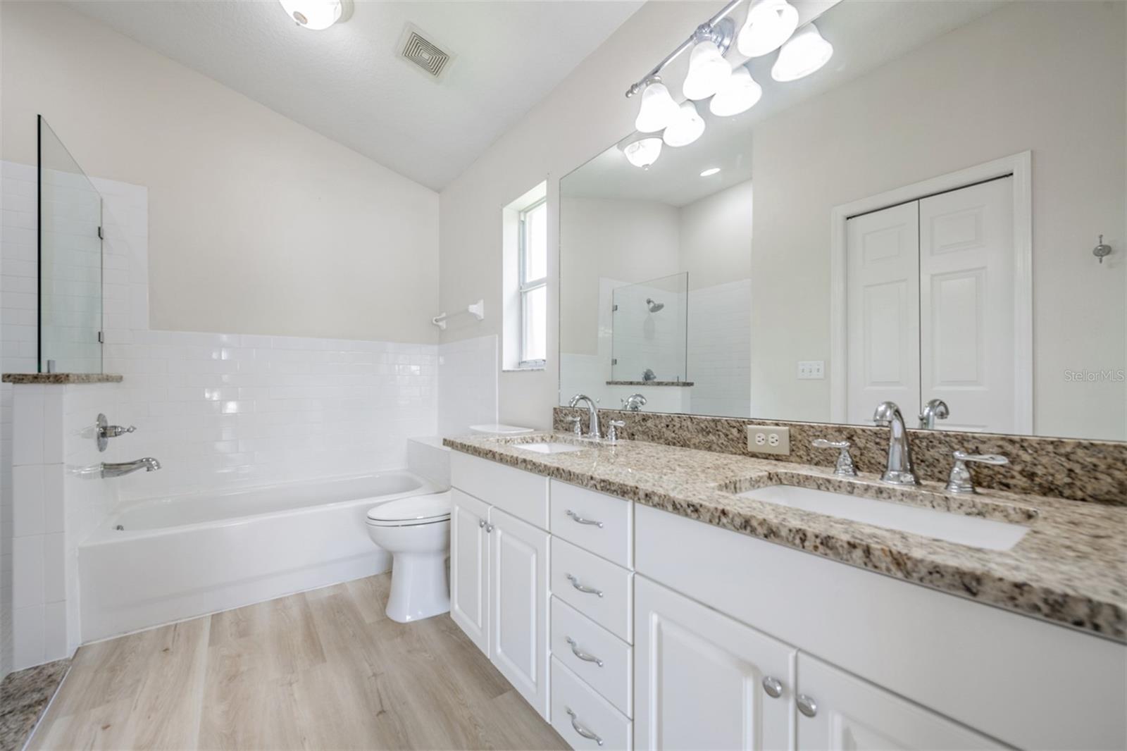 Master Bathroom, Double Vanities, New LVP Flooring, New Light Fixture, Granite Countertops and New Hardware.