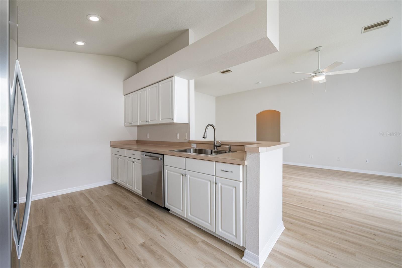 Open Kitchen, stainless steel appliances stay with the home and bar area.