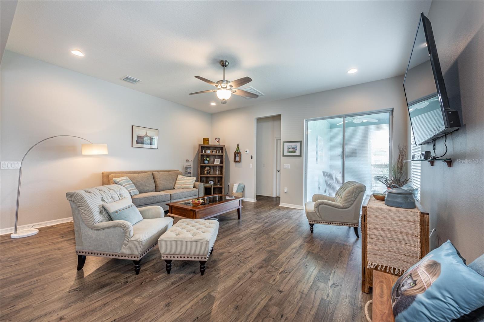 Inside the high ceilings and open floor plan and beautiful engineered wood floors with hand rubbed texture.  Sliders lead to private, enclosed side porch with screen for outdoor entertaining.