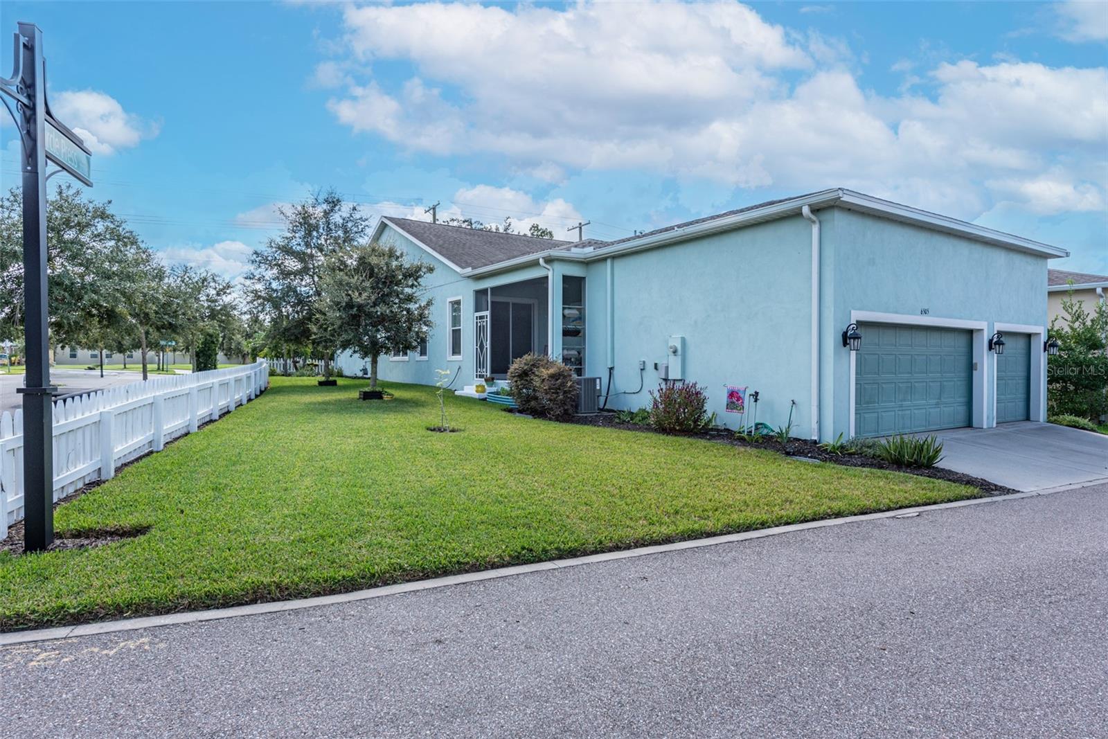 On a corner lot with a RARE attached 3 car oversized garage with 14’ ceilings, ceiling storage racks, and alley access with open parking spaces.