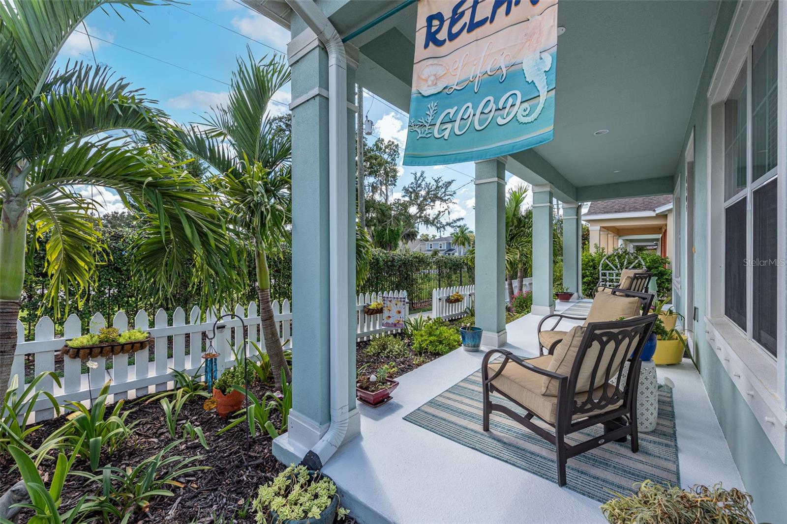 The colorful manicured garden and welcoming covered front porch makes an unforgettable first impression.