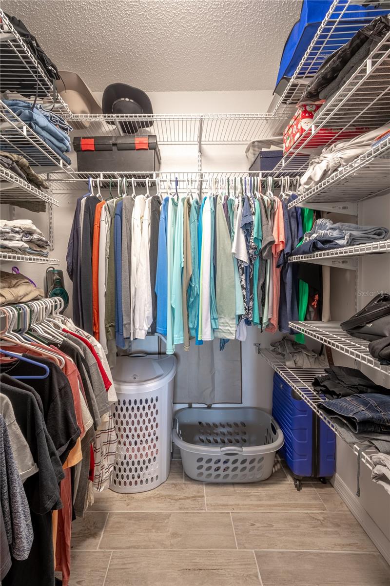 Primary bedroom walk-in closet with shelving.