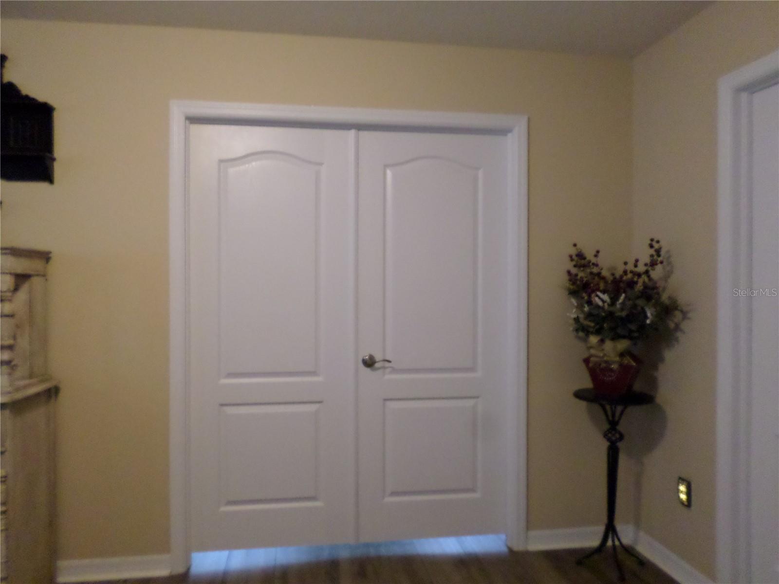 Double doors leads into the Primary Bedroom