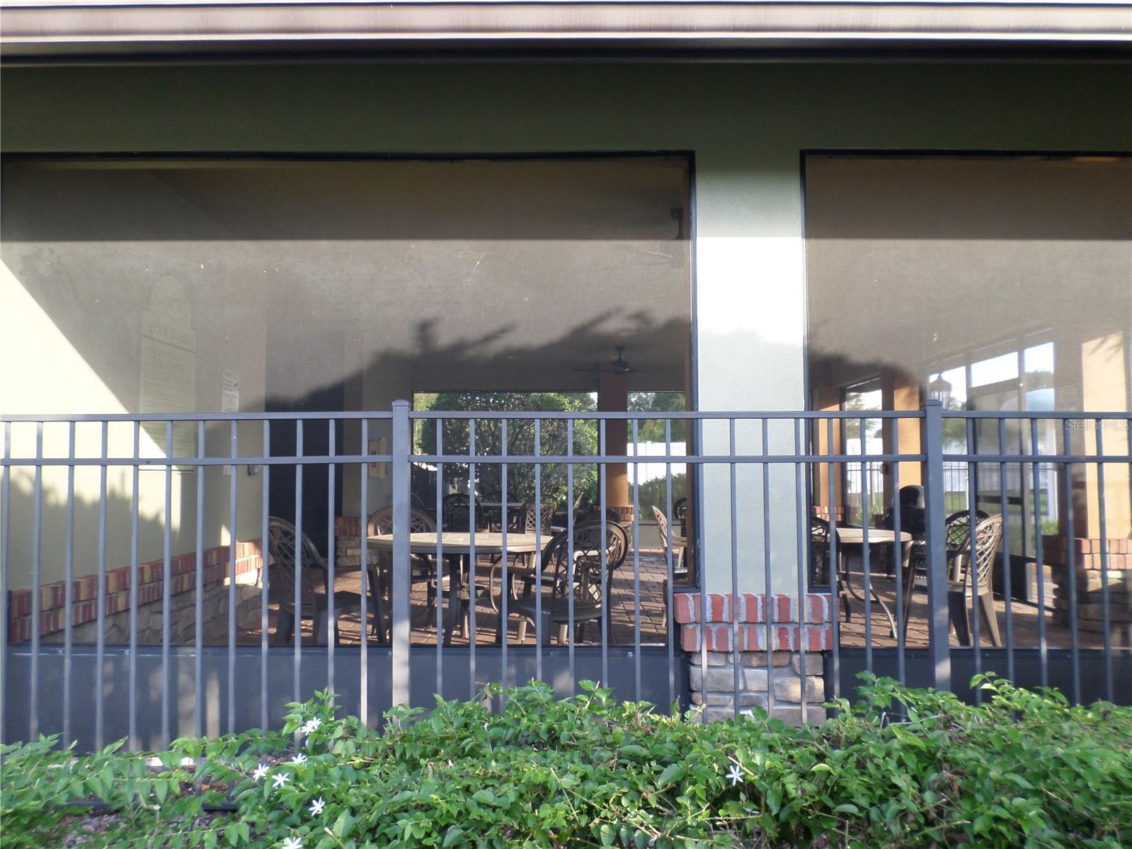 Community pool area has table and chairs