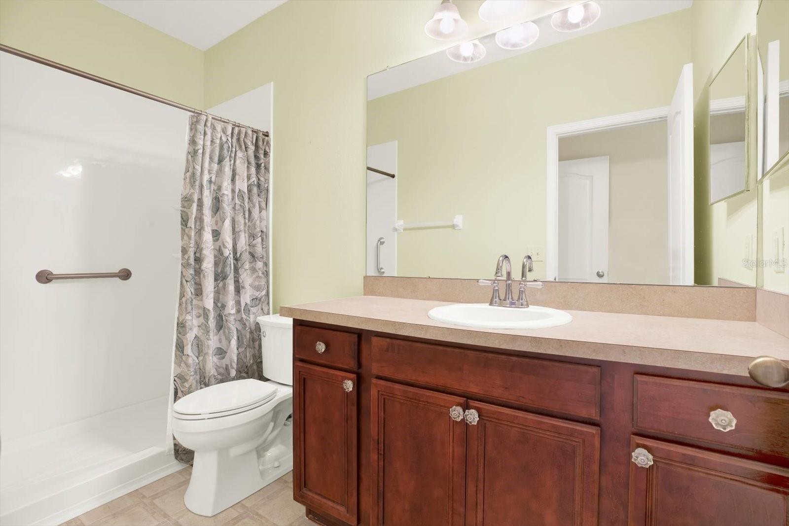 The master bathroom has been recently upgraded with a brand-new walk-in shower, complete with stylish tile accents and a spacious, open design. This fresh addition enhances the bathroom, offering a modern and convenient touch to the space.