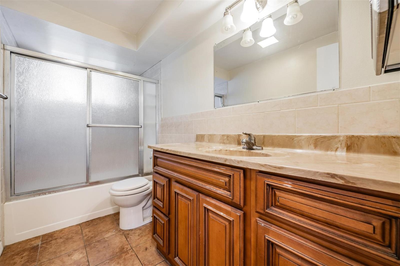 Tub/shower bathroom near primary bedroom