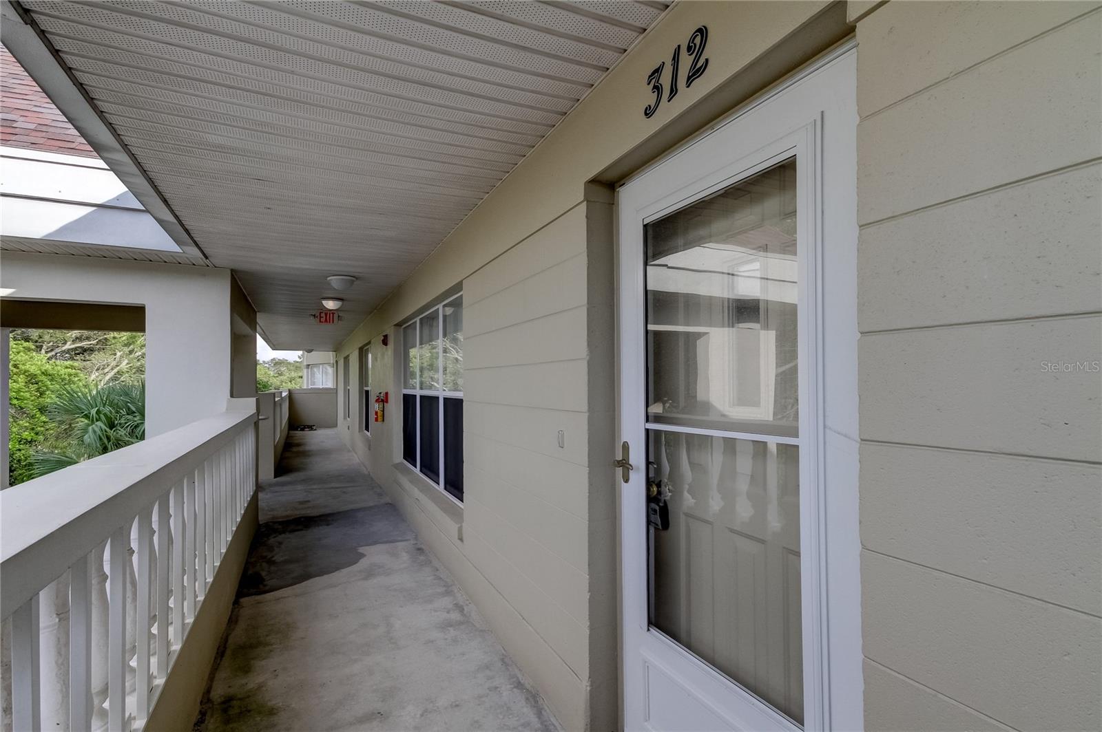 Front door exterior looking towards hallway towards staircase.