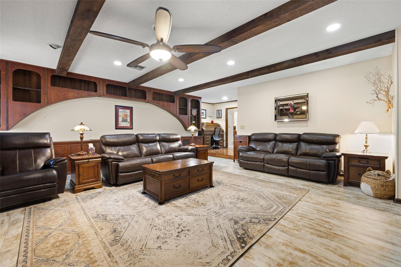 Family Room Beamed Ceilings, Updated Plank Flooring & Wood Burning Stone Fireplace