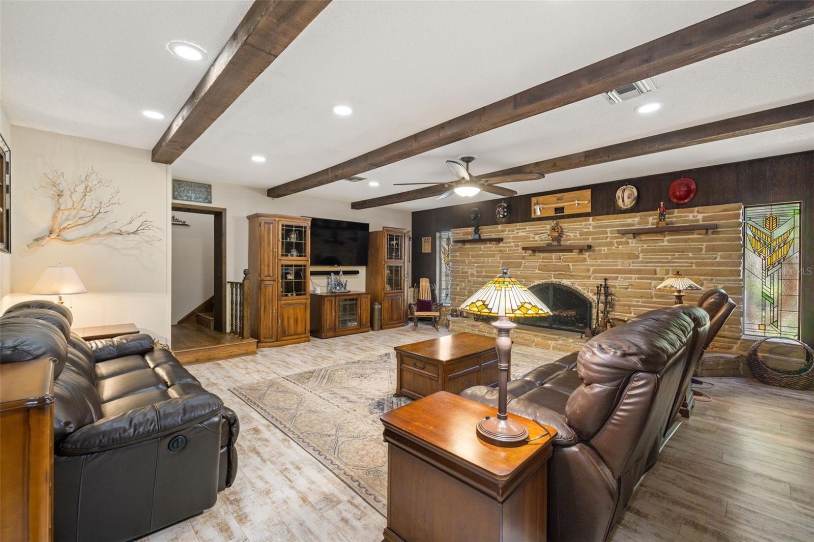 Stained Glass Windows on either side of Wood Burning Stone Fireplace