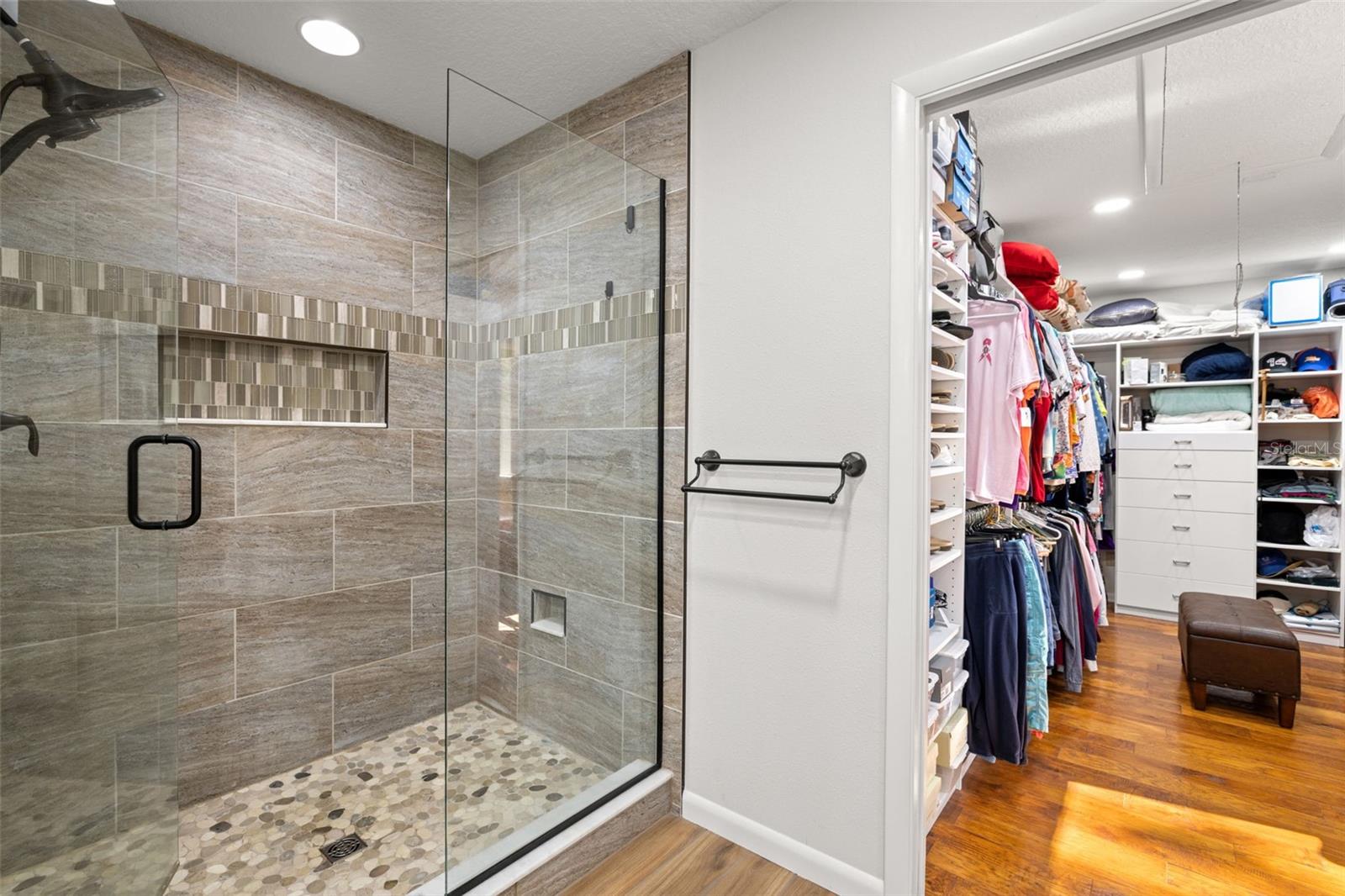 Spacious Tiled Shower with Frameless Glass Door with built in shower niche