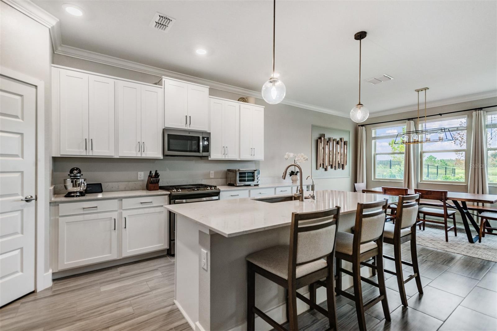 Light and bright kitchen with stainless steel GE appliances