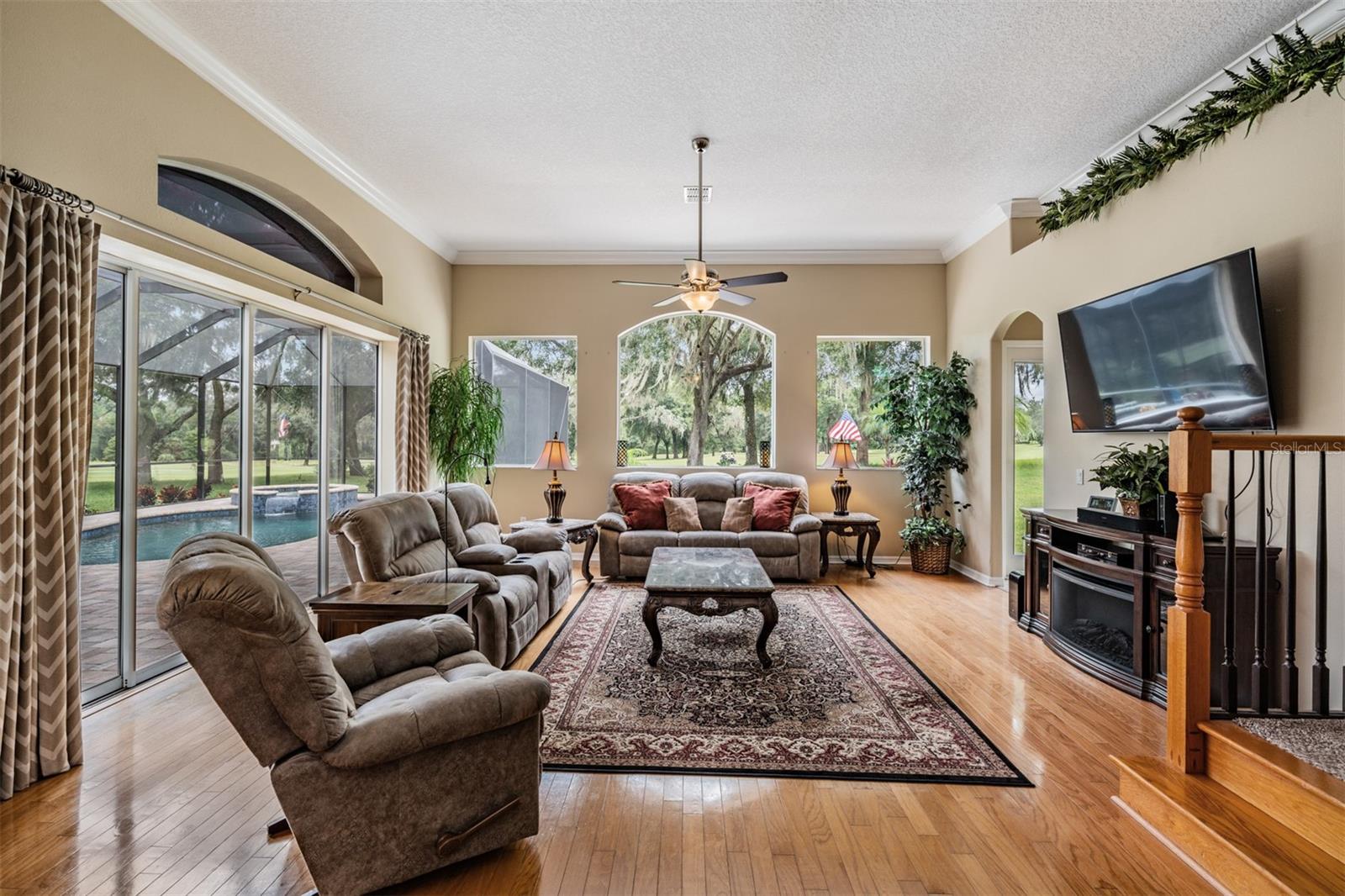 Sliders from family room to pool area...Windows have golf course views!