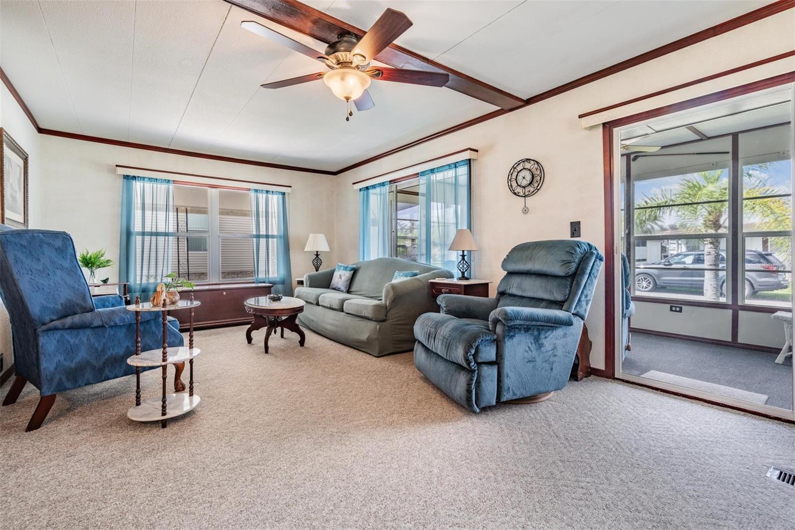 Living room opens to front enclosed porch