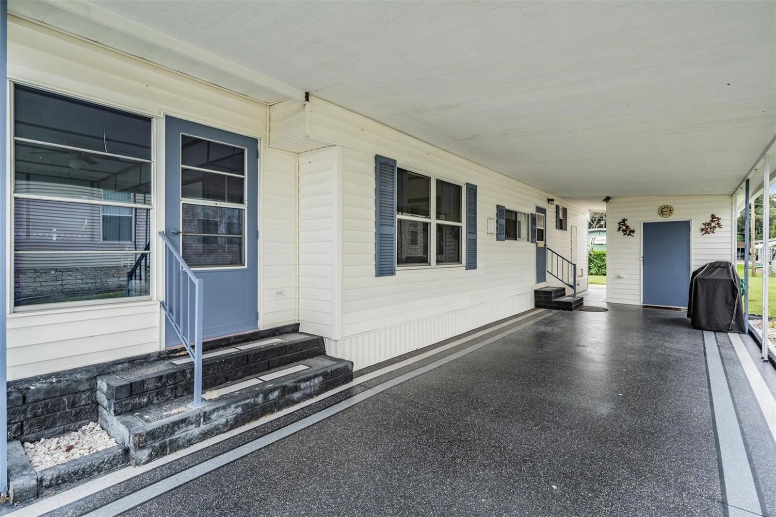 Large carport with painted driveway