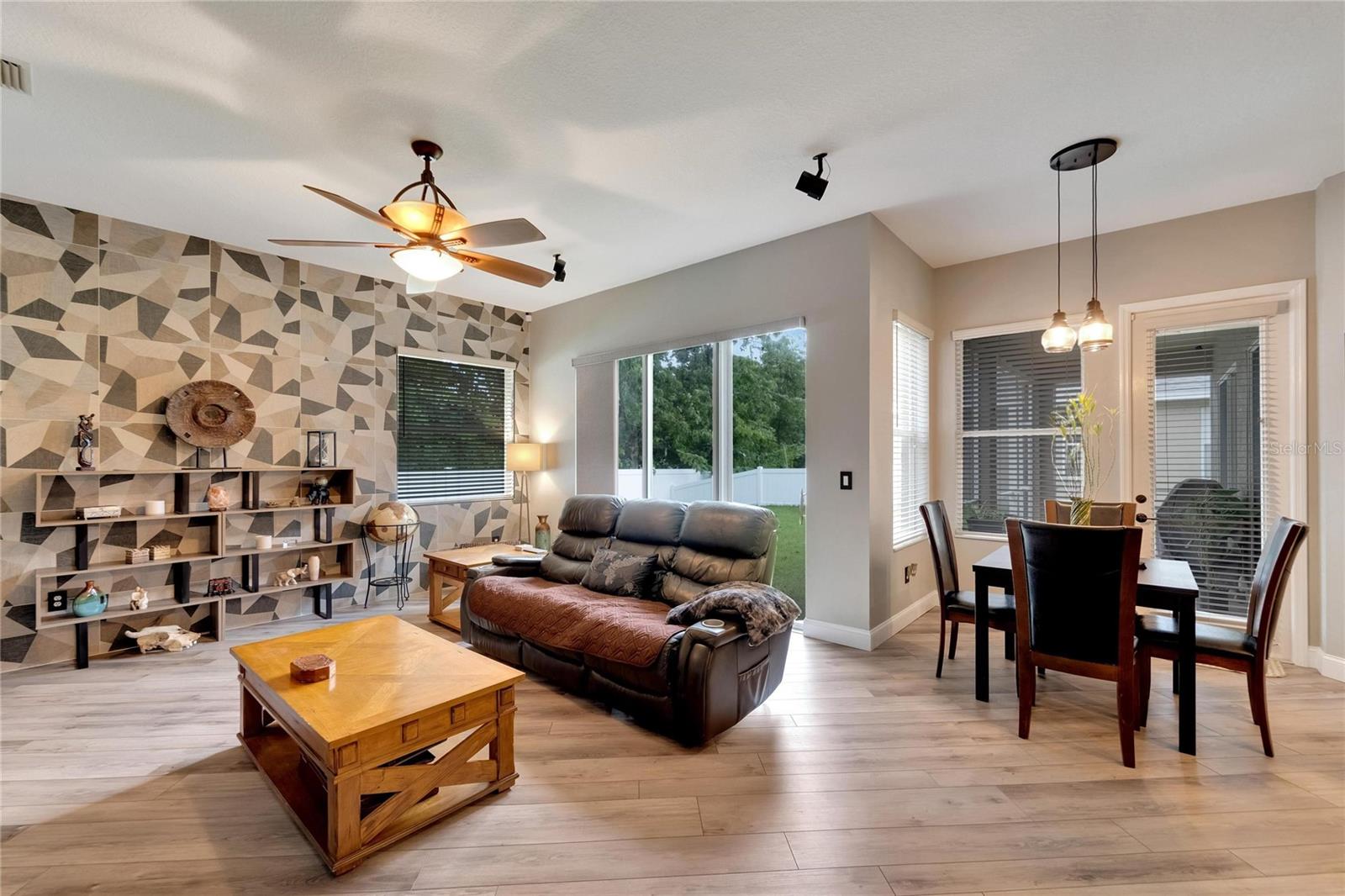 Upgraded lighting, ceiling fan and take a look at that statement wall.