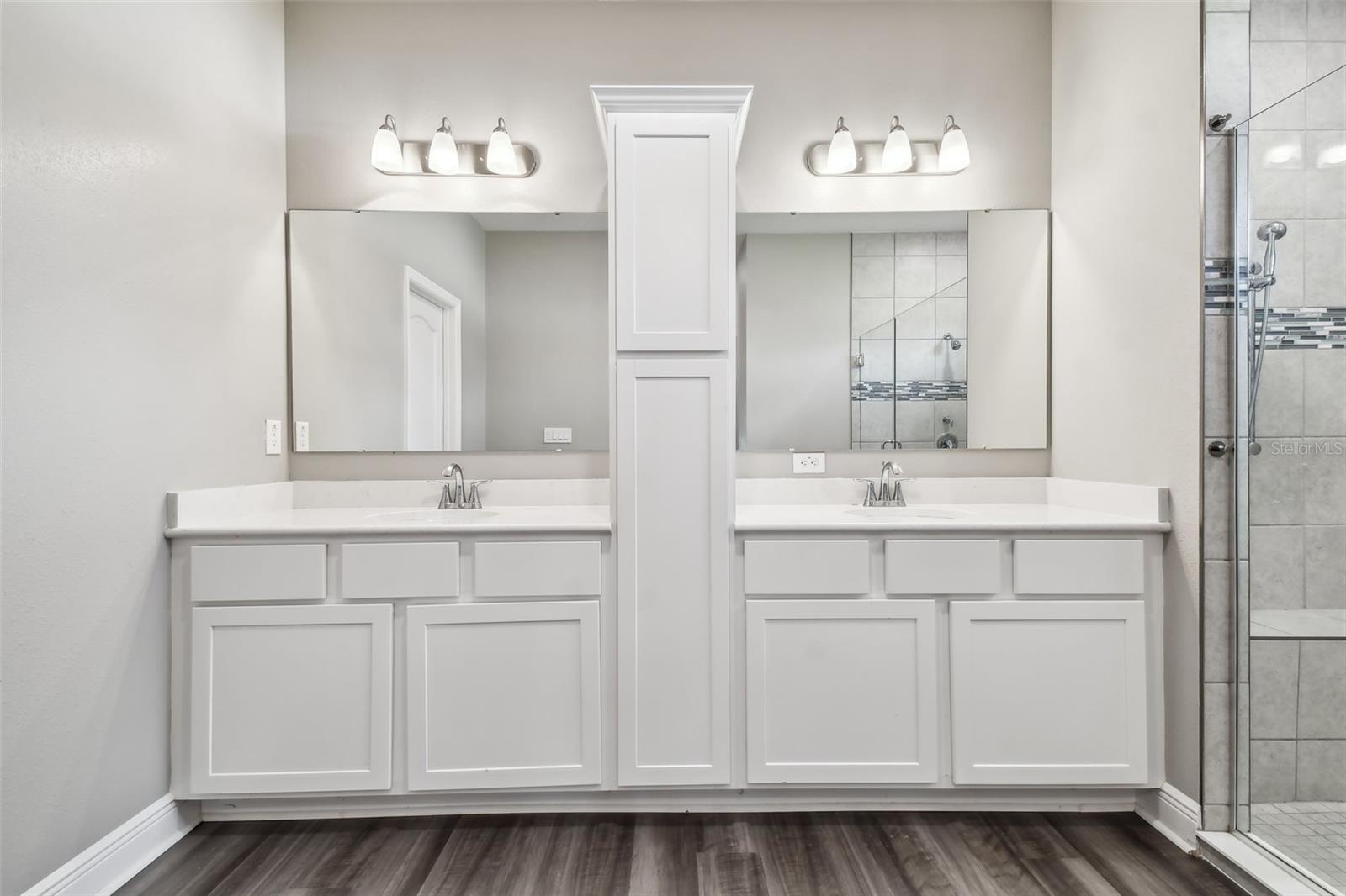 Primary bath. Luxurious double vanity. Double sinks. Quartz counters. Decorator light fixtures.