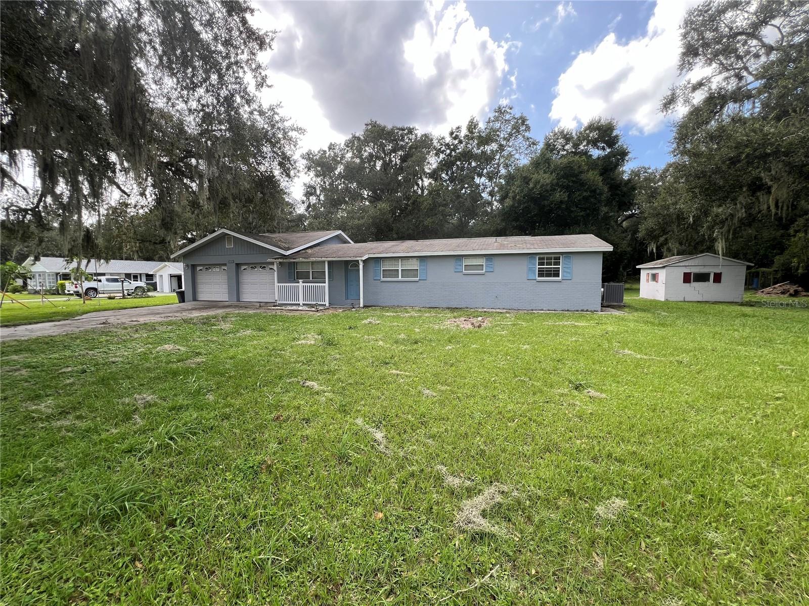 Frontal view with side storage shed - 4043 Burrows RD, Zephyrhills, FL