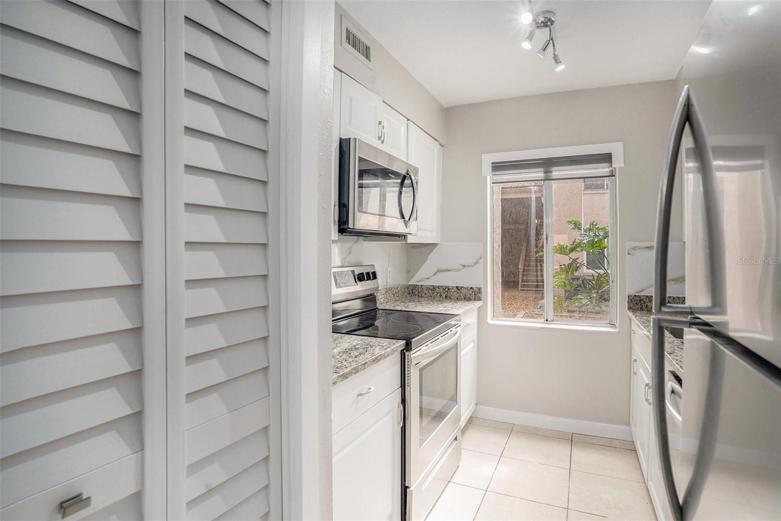 Kitchen- with granite countertops and stainless steel appliances