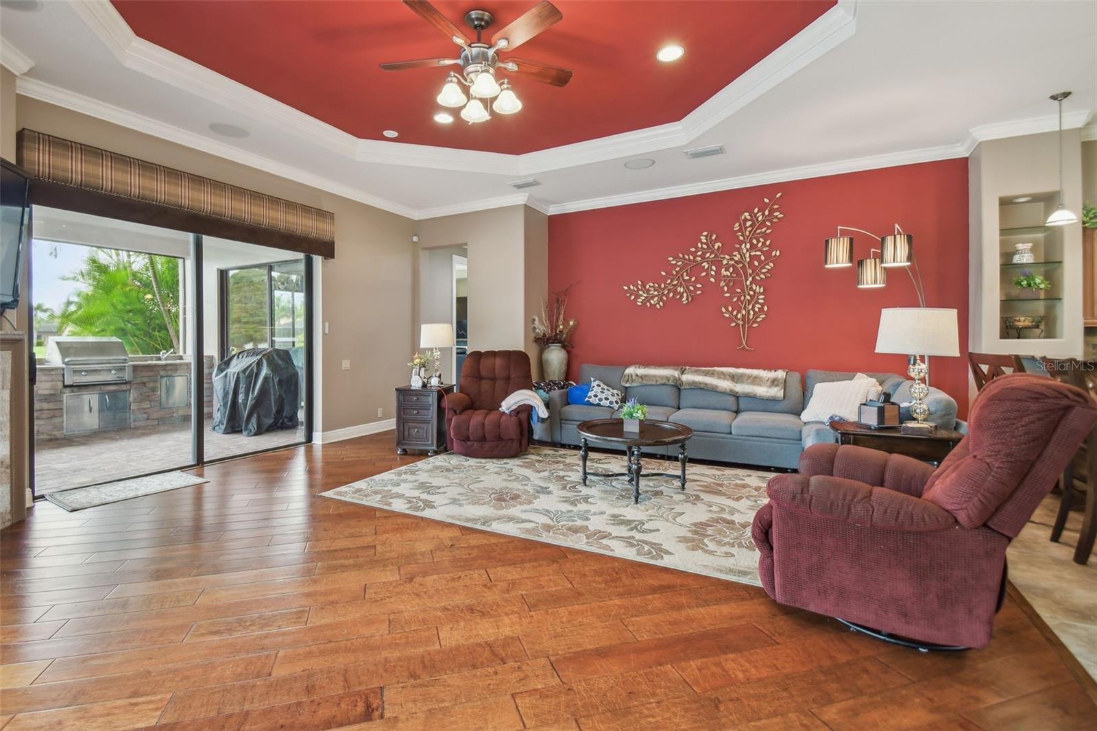 Family room with tray ceiling & surround sound.