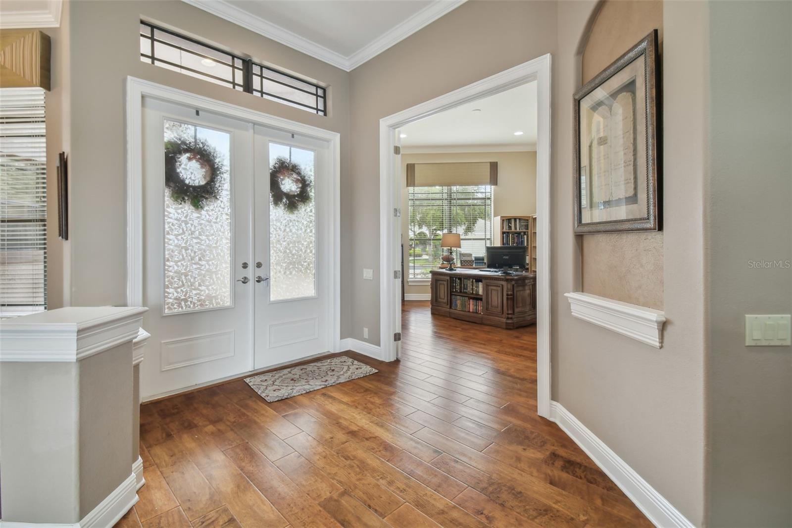 Foyer and den with double french doors.