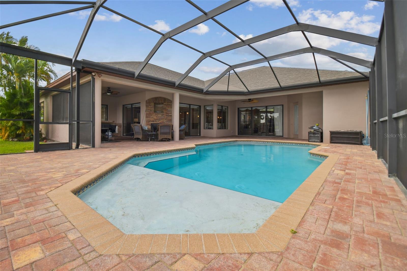 Spacious covered lanai areas with ODK & dbl sided fireplace.