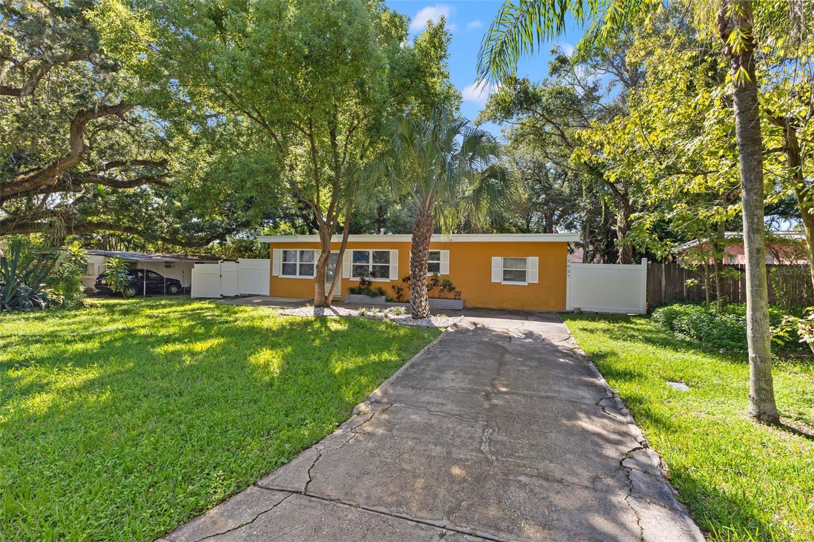 Additional view of house with driveway.