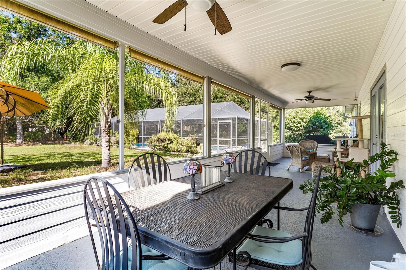 Delightful back screened porch with large pool beyond