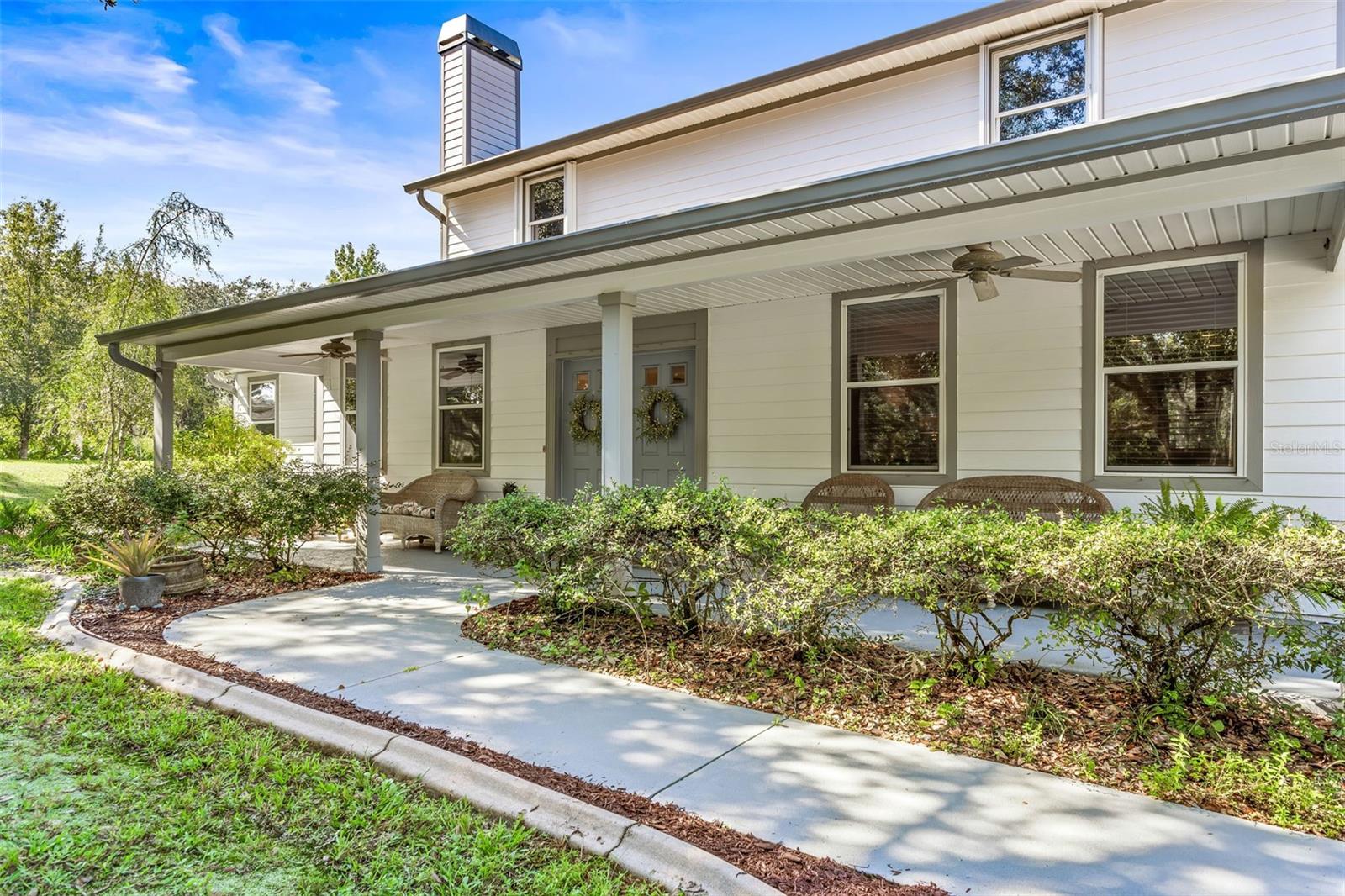 Front porch runs the whole length of the front of the house