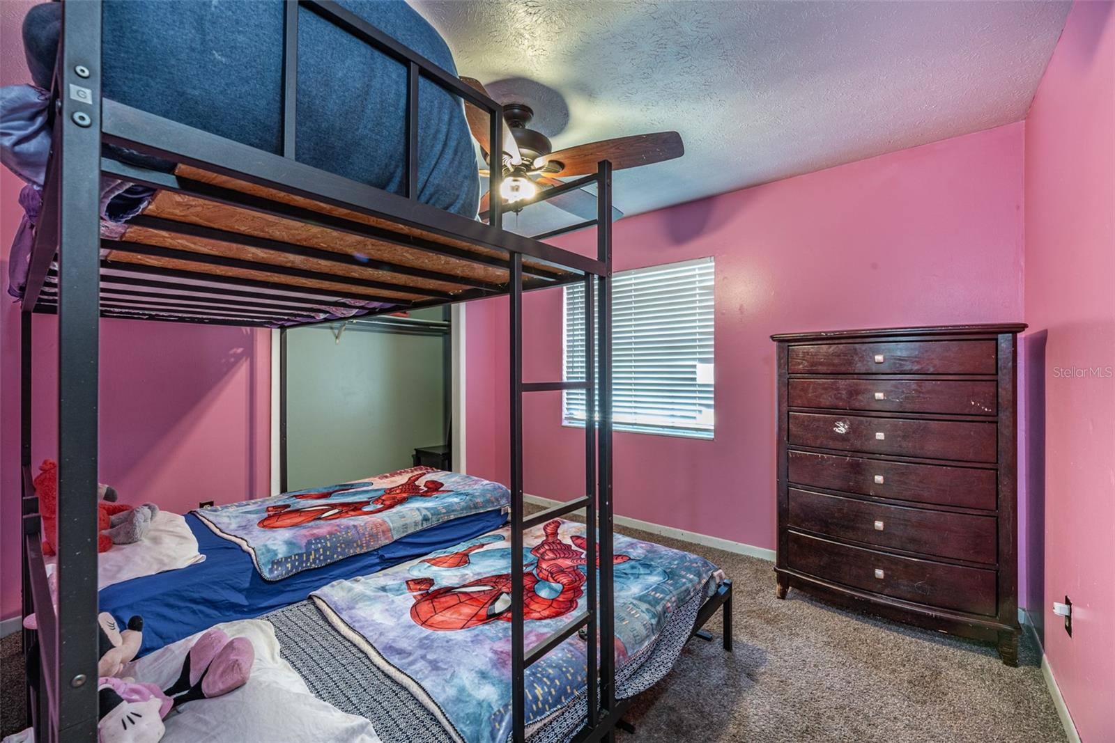 Secondary bedroom #2 is 10'x10' with a built-in closet, ceiling fan and recently installed carpet.