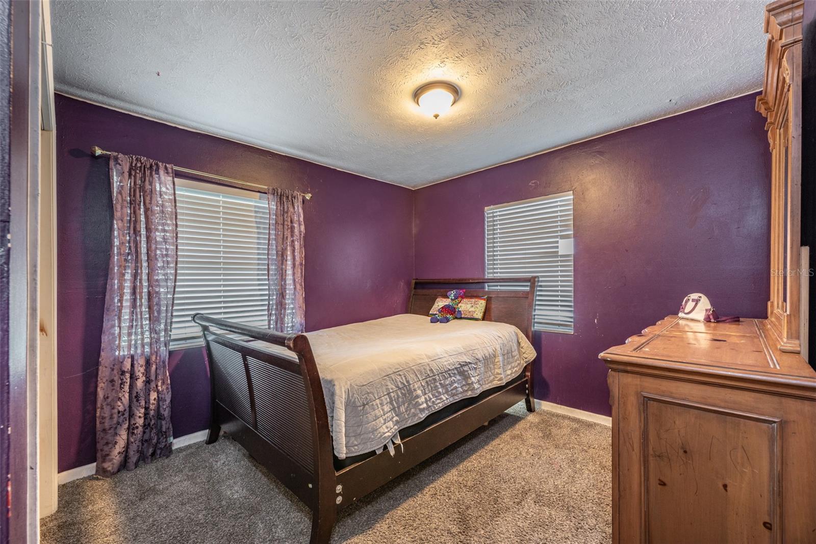 Secondary bedroom #3 is 12'x10' with a built-in closet, and recently installed carpet.