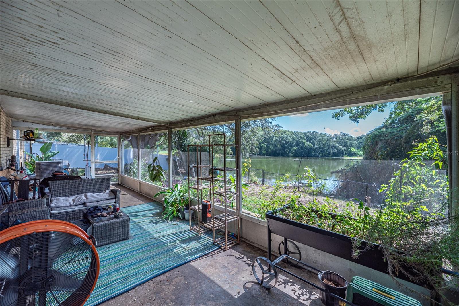 30' x 10' covered and screened back lanai just off the living room overlooking a pond.