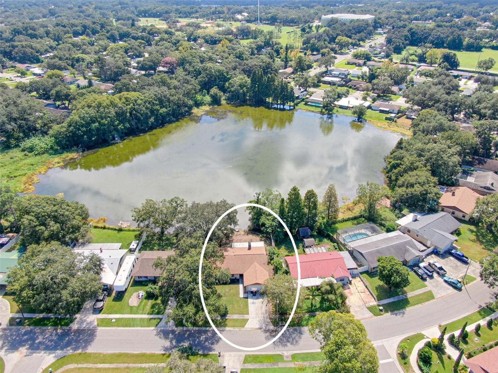 Aerial view of home and lot on pond in Presidential Manor.