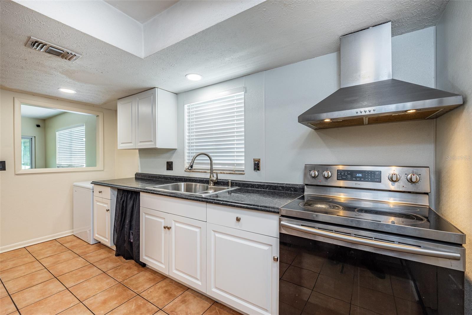 The kitchen has convenient access to the Dining & Living rooms as well as the garage for unloading groceries. Dishwasher & Range to be replaced by Owner prior to close.