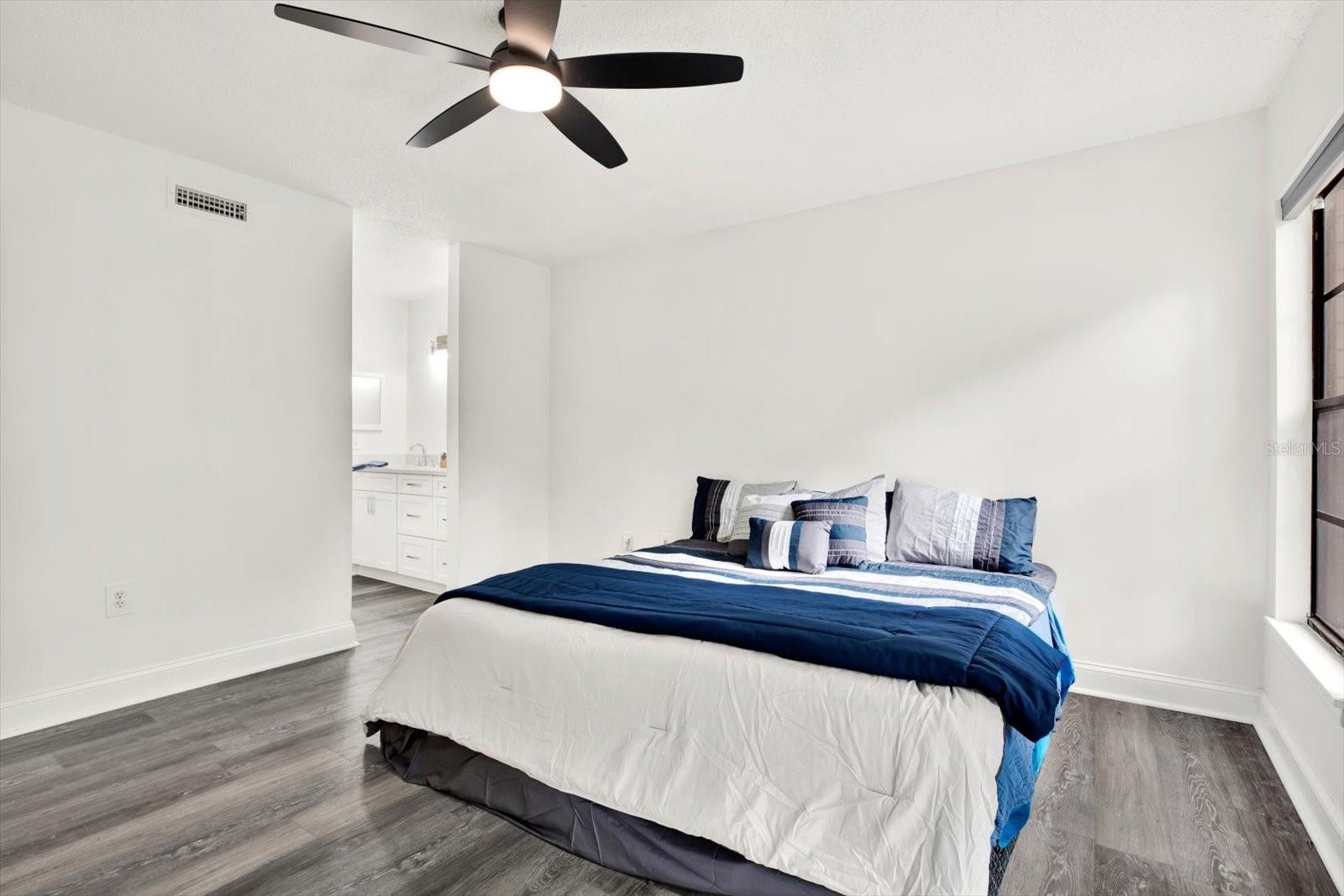 Primary bedroom with walk in closet and en-suite bathroom