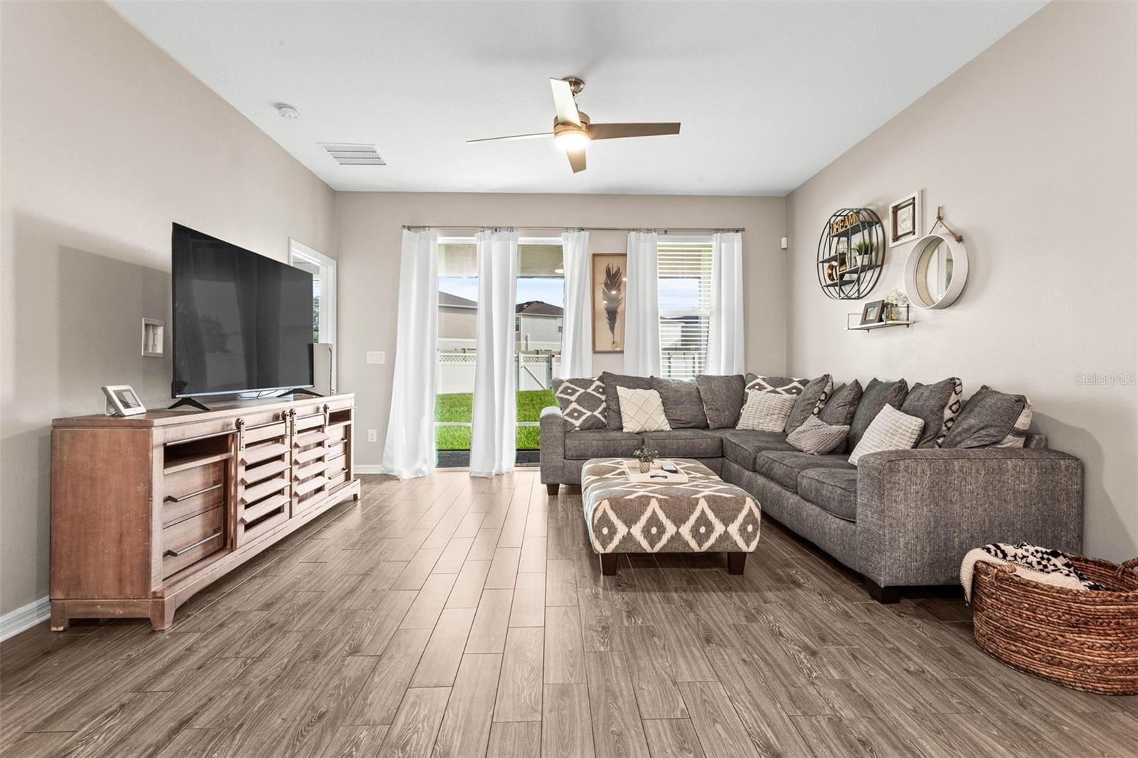 Woodgrain ceramic tile flooring, bright open view from the living room.