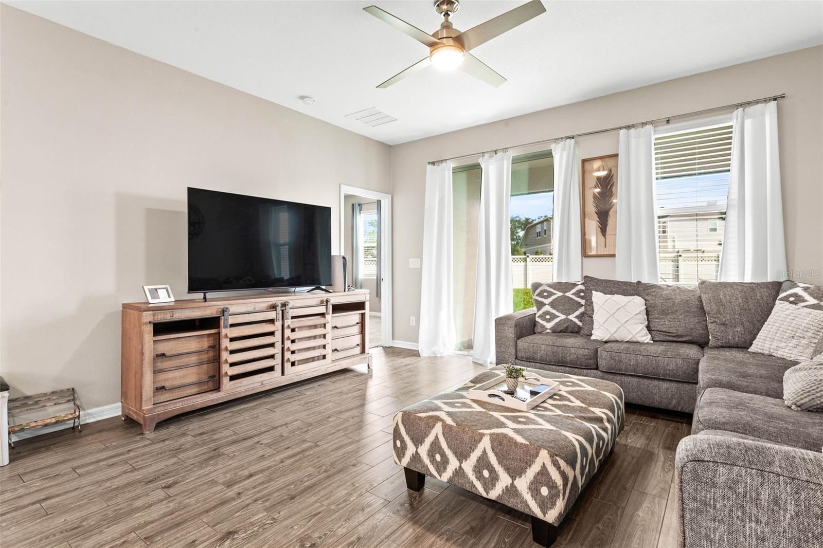 Living room has abundant natural light from the sliding glass doors.