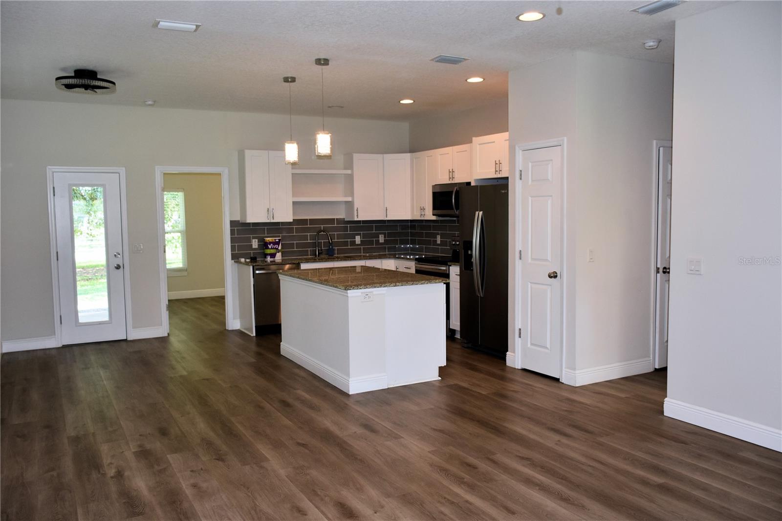 View toward kitchen with dining area on the left