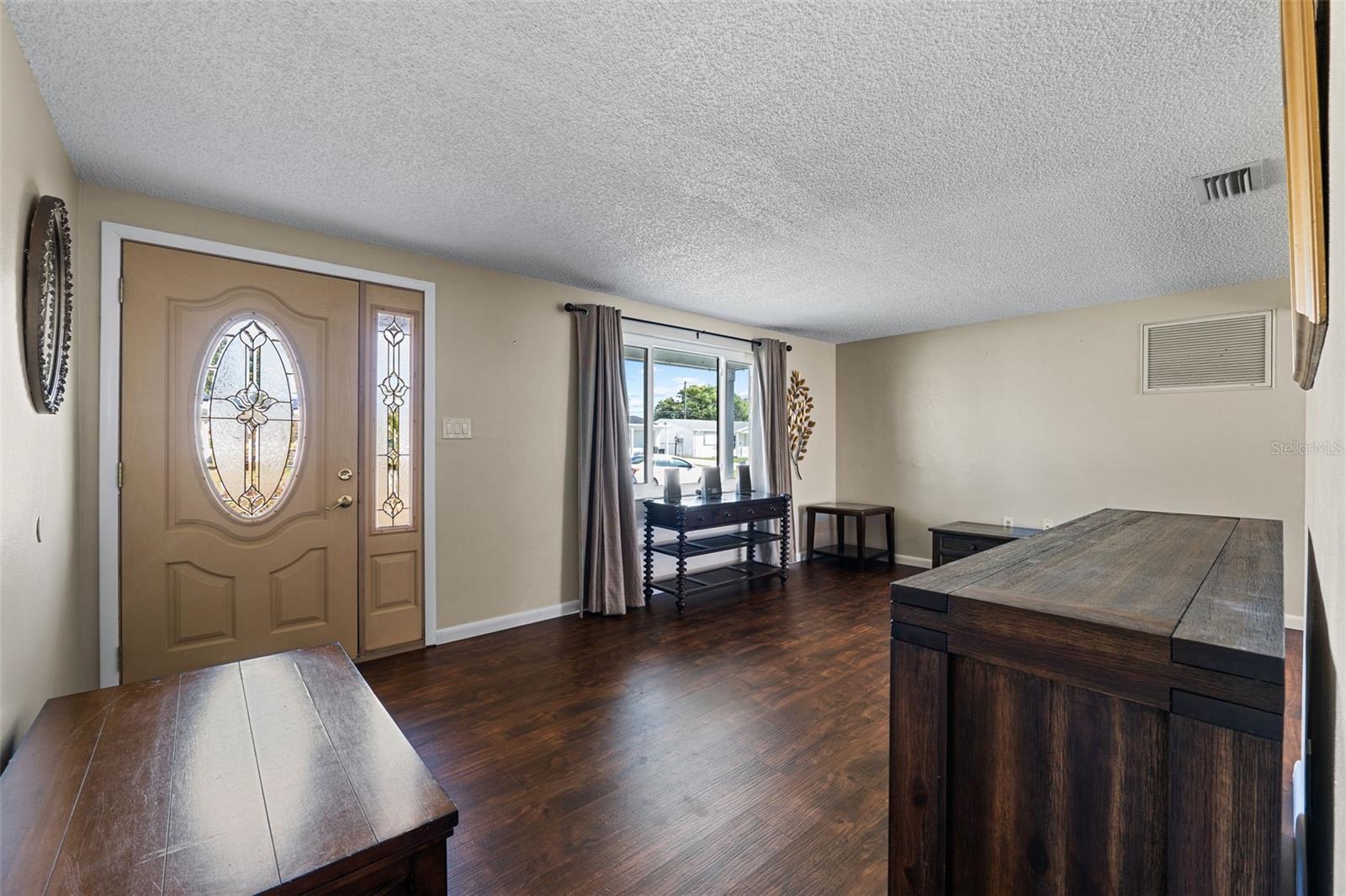 Spacious living room with extra large window and new flooring