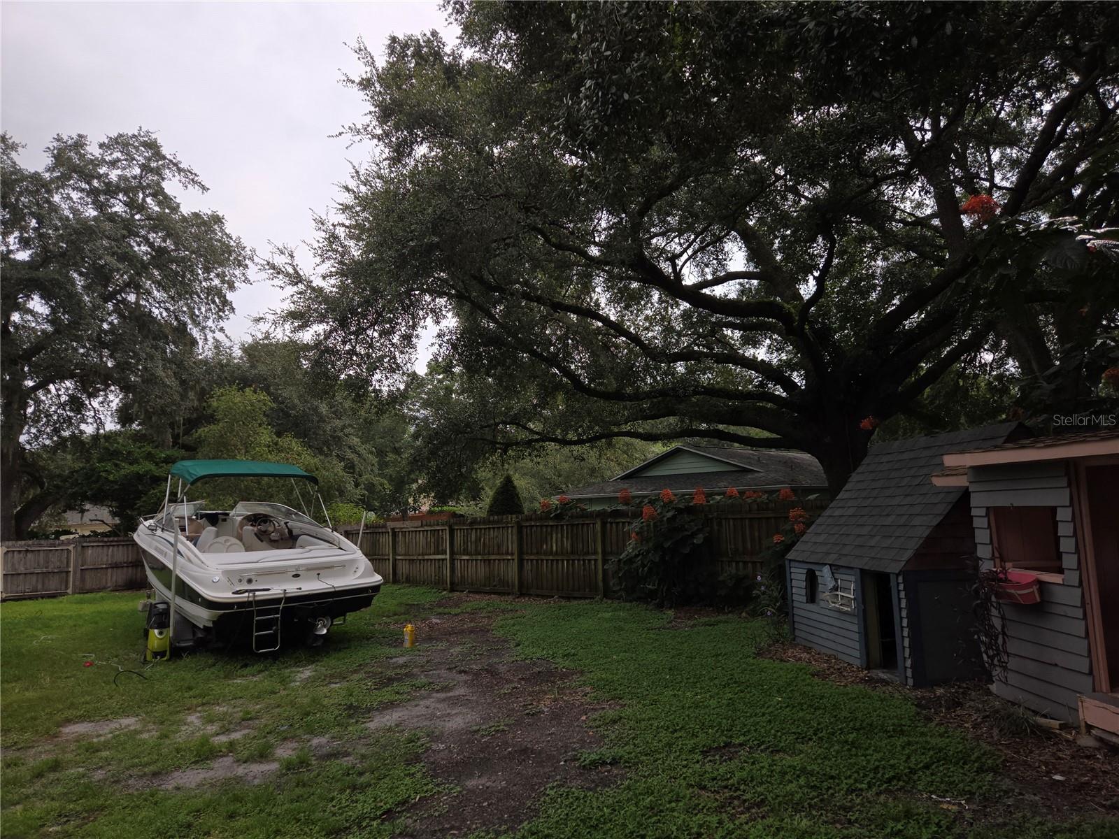 Right side yard. Boat will not remain.  Play house