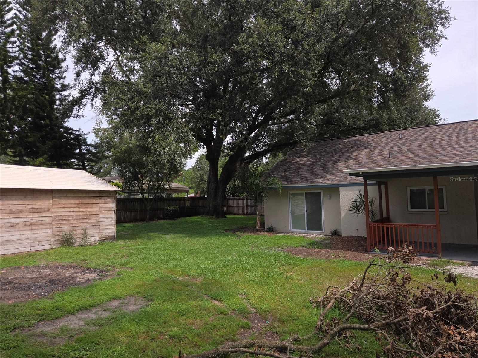 View of back yard to the west showing large enclosed storage