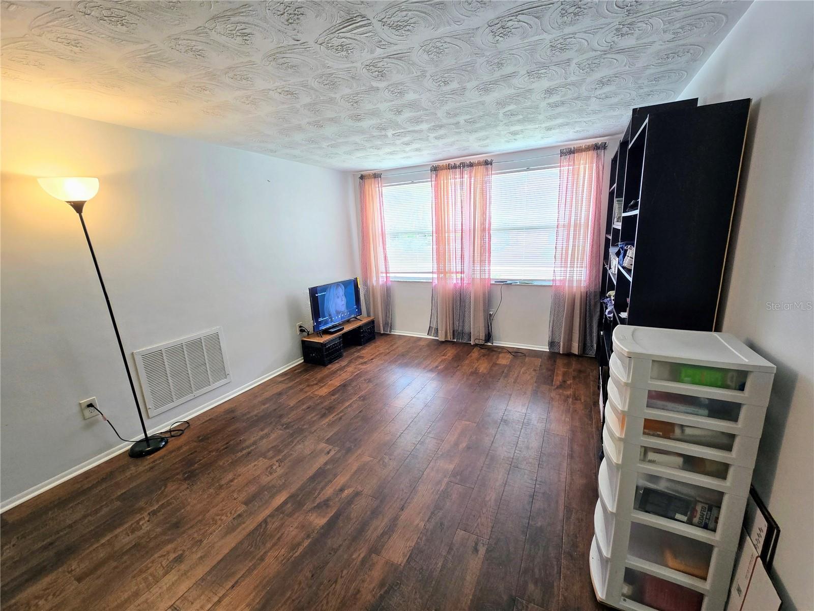 Bonus Room with LVP Flooring and view of front yard