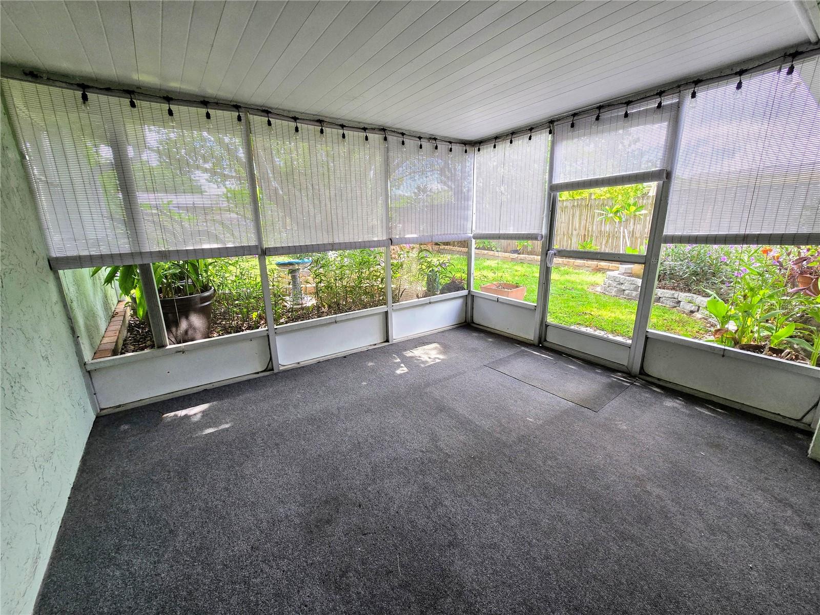 Screened porch with view of Beautiful backyard