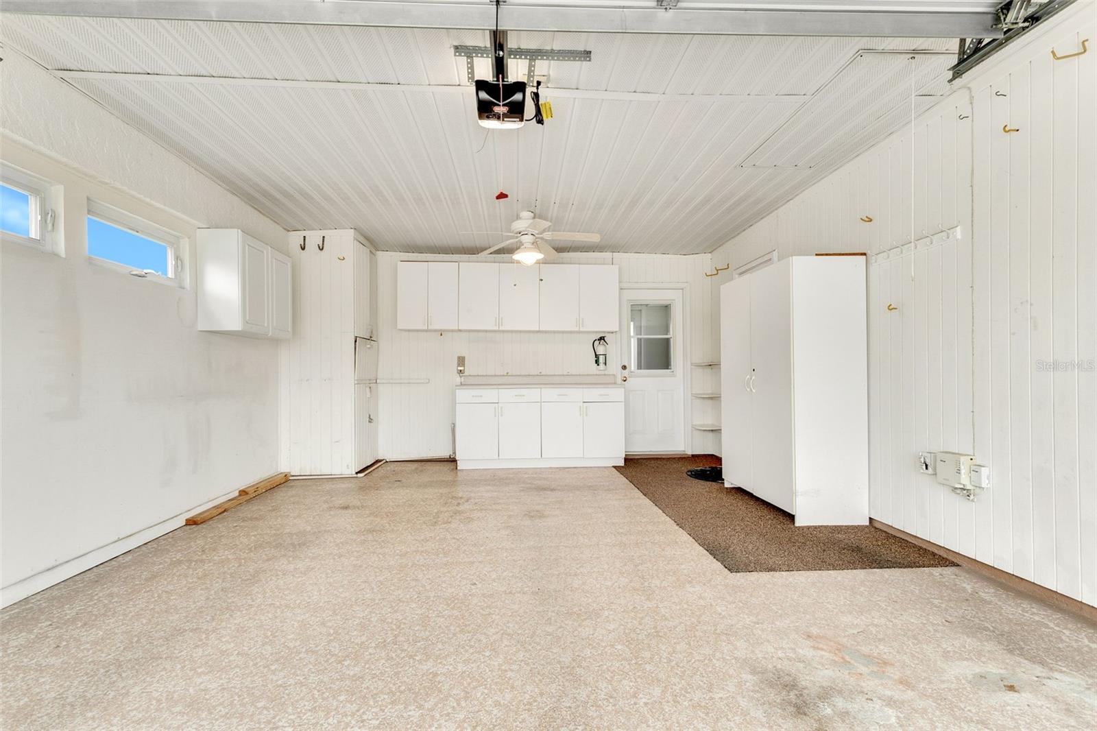 Oversized Garage with room for Golf Cart and Lots of Storage Cabinets