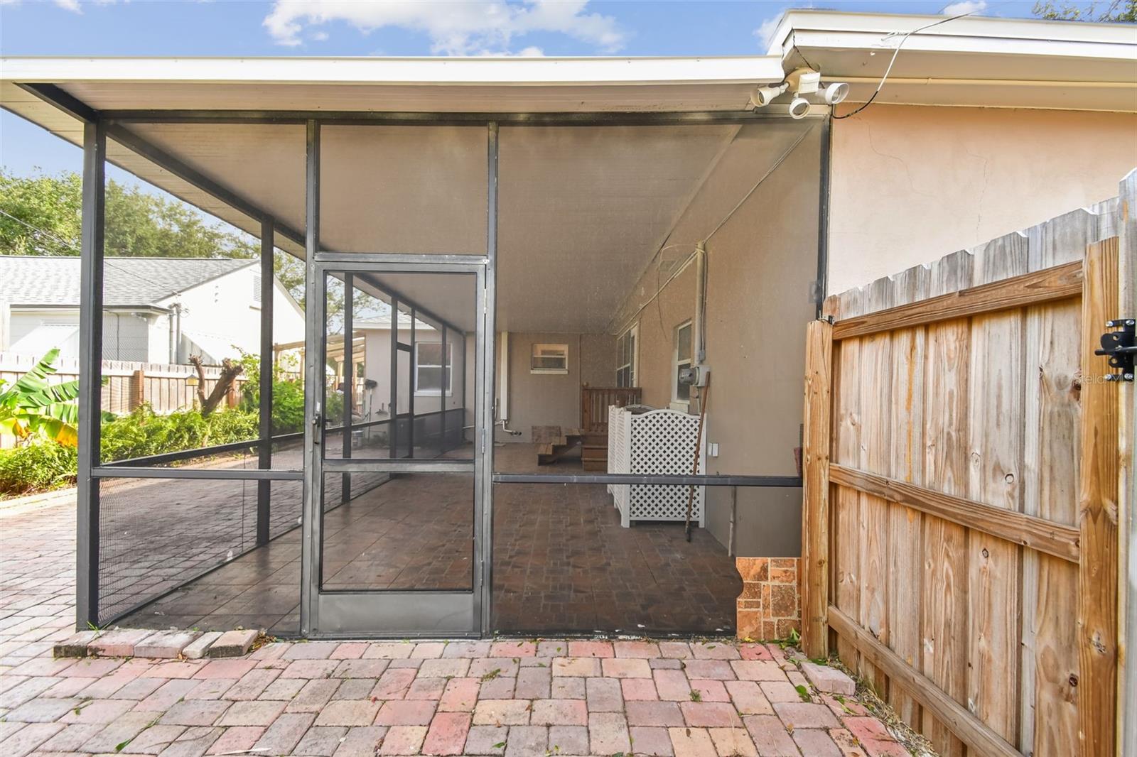 backyard looking into screened lanai with gate to rear parking pad