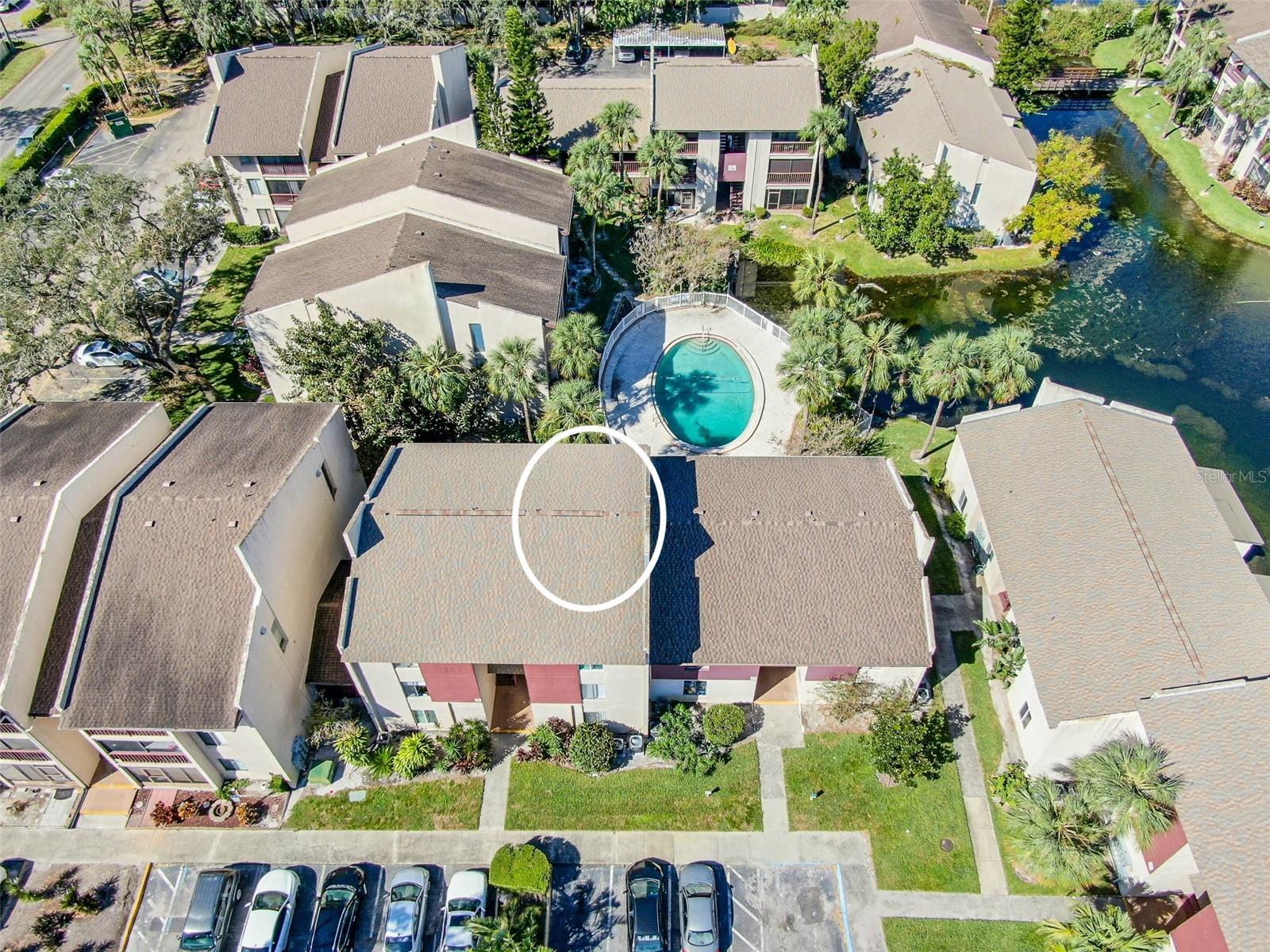 Arial view of Building #35 and Unit #200. Plenty of open parking is available for visitors and guests, alongside the convenience of an onsite laundry facility.