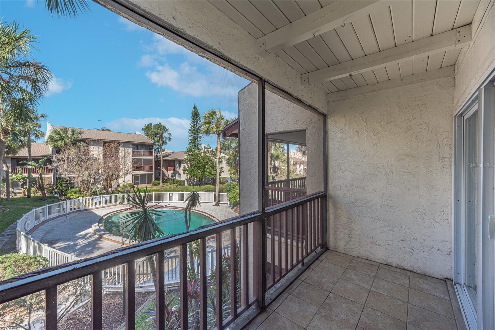 Step through the sliders onto your large, screened balcony. This community boasts 3 pools for your enjoyment, a clubhouse, lush courtyards, ponds, and park-like setting.