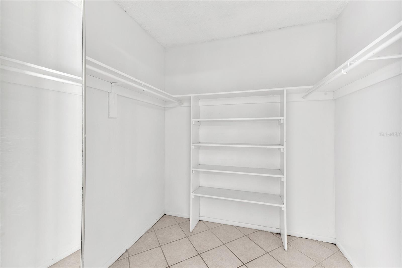 Walk-in closet with built-in shelving will keep you organized.