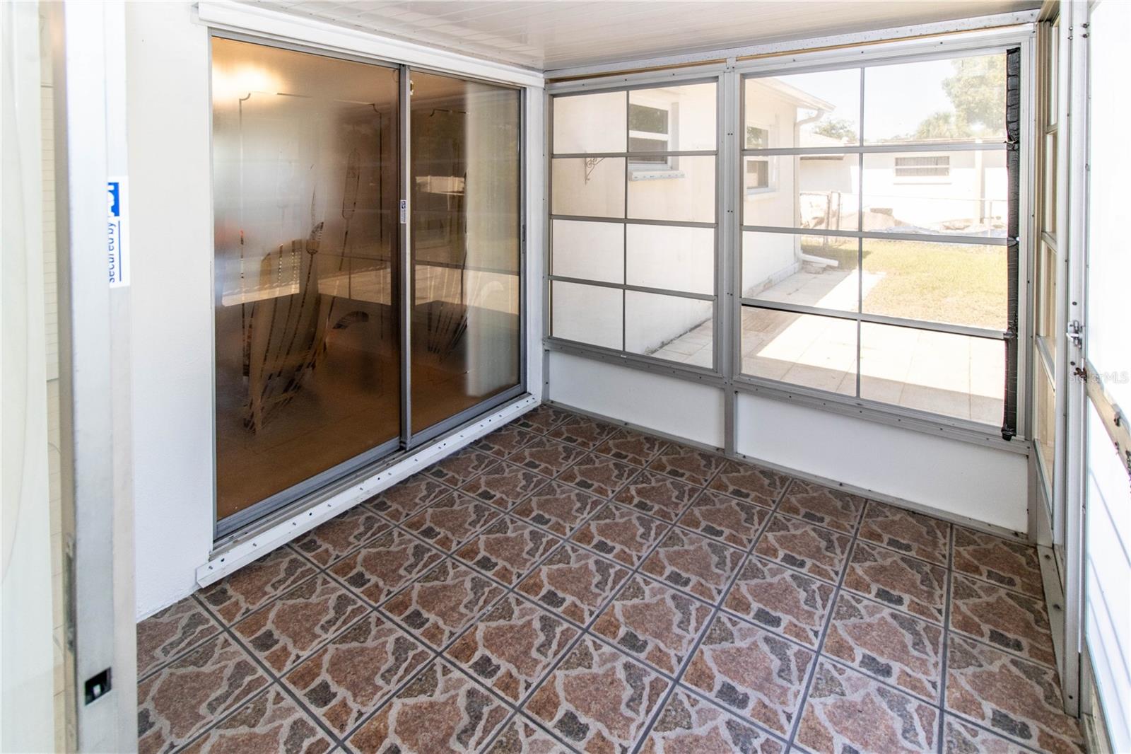 Enclosed Porch With Sliders From Dining Room & Den